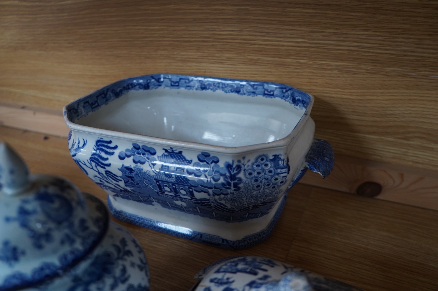 A group of blue and white Willow pattern china, 19th century and later and a Meissen cup and. Saucer. (12).